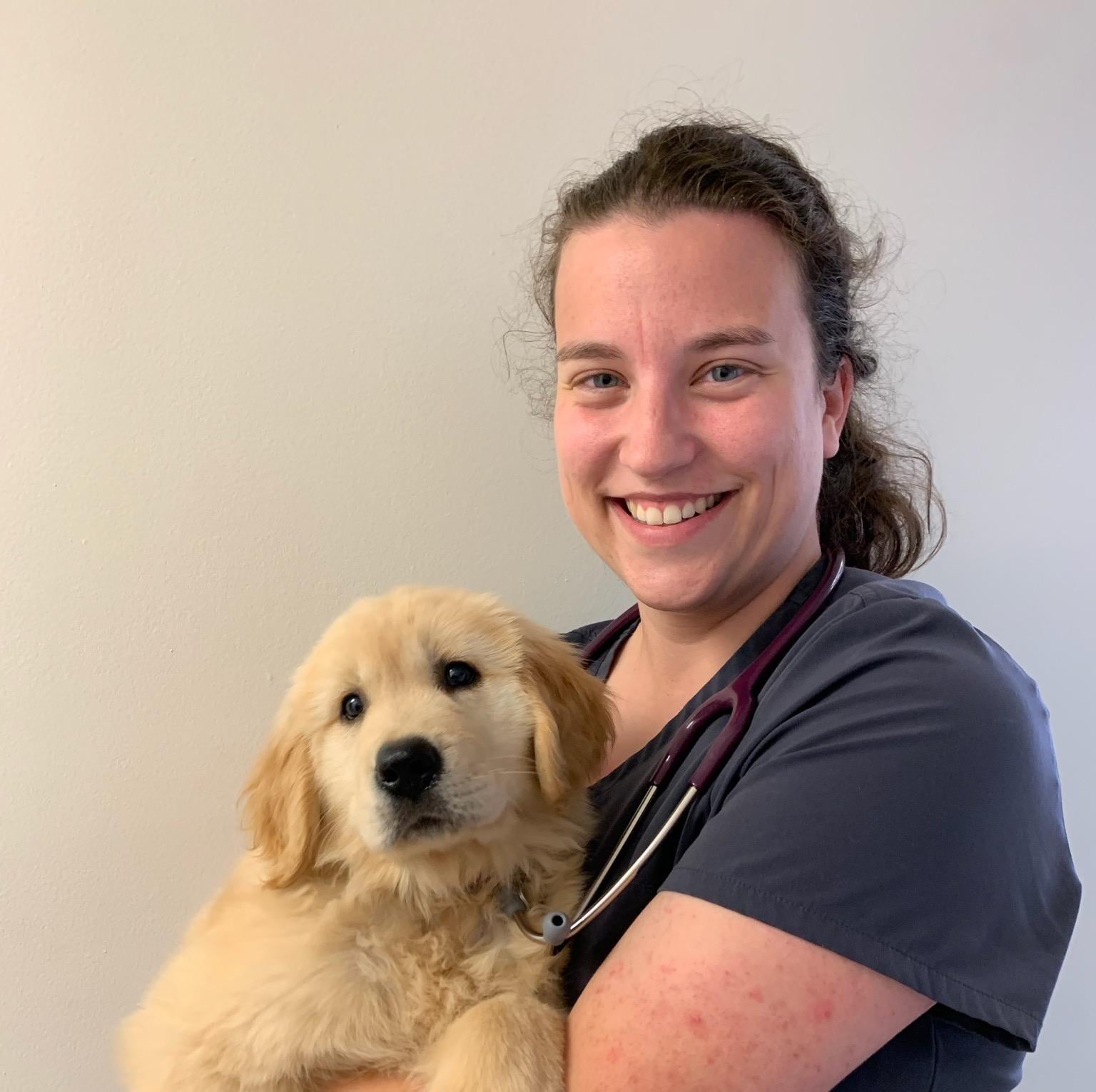 Photo of Dr. Julie Van Scoik with a dog.